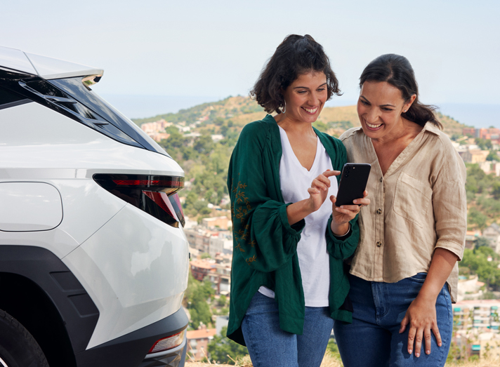 Women looking at mobile phone, coverage